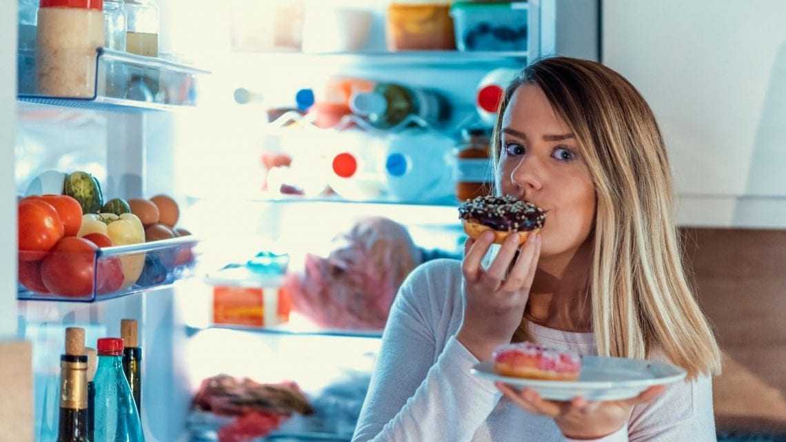 woman eating late night snacks when living alone